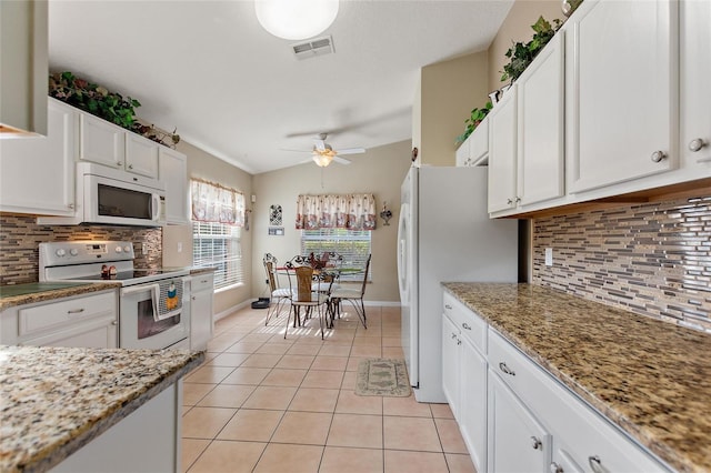 kitchen featuring light stone countertops, ceiling fan, tasteful backsplash, white appliances, and white cabinets