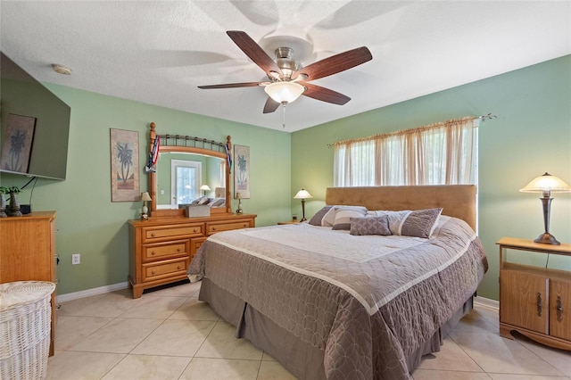 tiled bedroom featuring ceiling fan and a textured ceiling