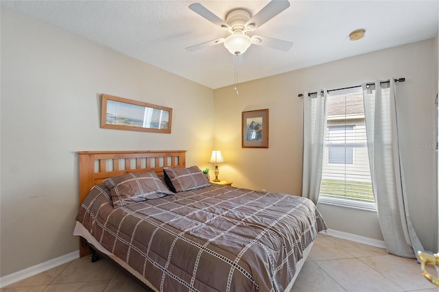 tiled bedroom with ceiling fan