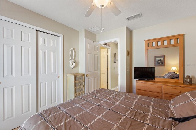 bedroom with a closet, ceiling fan, and a textured ceiling