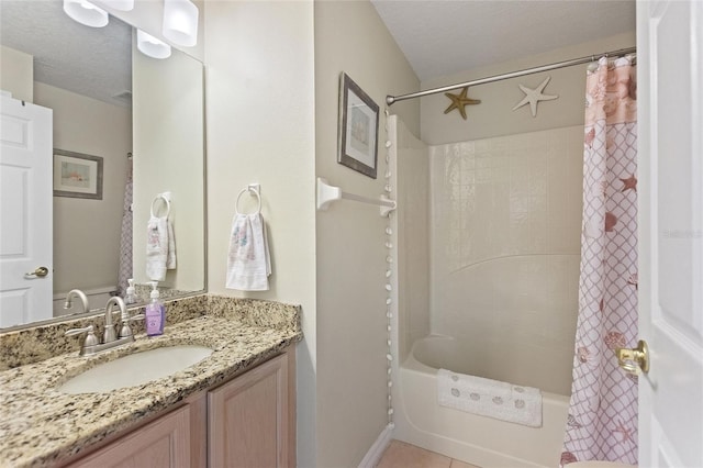 bathroom featuring a textured ceiling, tile flooring, large vanity, and shower / bath combo with shower curtain