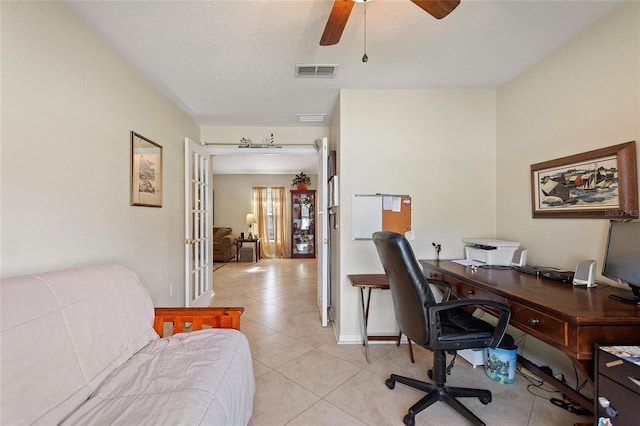 tiled office featuring ceiling fan and a textured ceiling