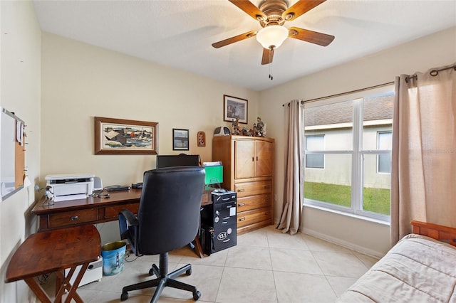 tiled home office featuring ceiling fan