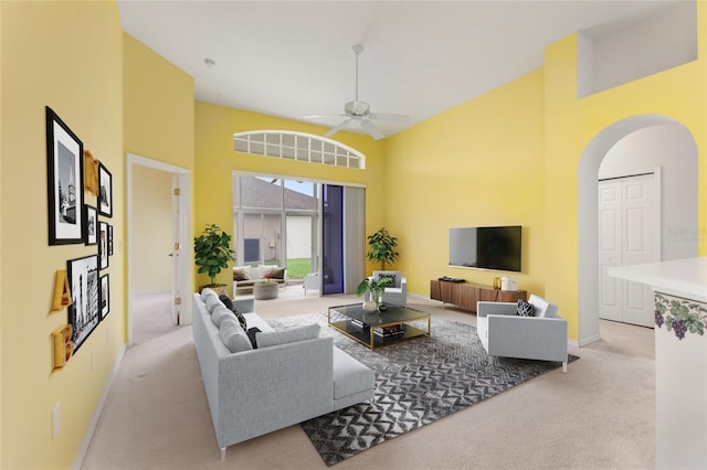 living room with light carpet, high vaulted ceiling, and ceiling fan