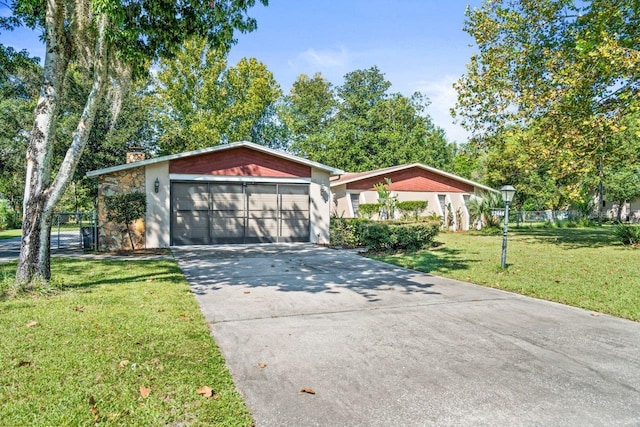 single story home featuring a front yard and a garage