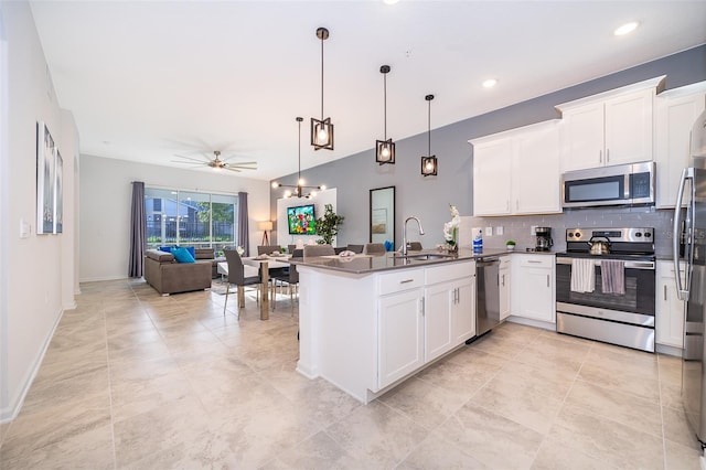 kitchen featuring white cabinets, pendant lighting, appliances with stainless steel finishes, and sink