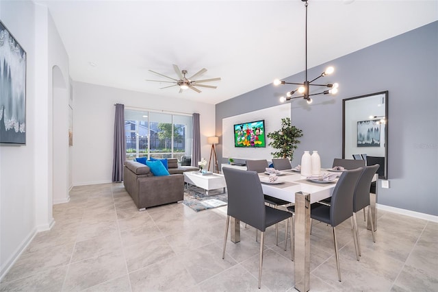 dining area featuring ceiling fan with notable chandelier and light tile flooring