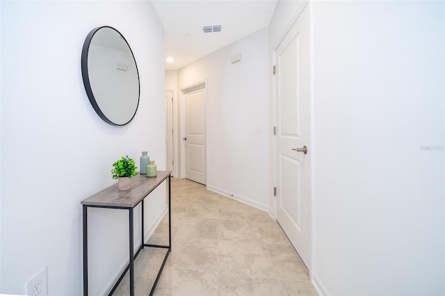 corridor featuring light tile floors