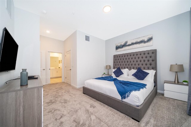 carpeted bedroom featuring connected bathroom