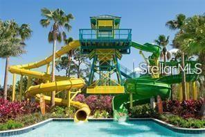 exterior space with a water play area and a water slide