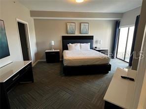 bedroom featuring dark colored carpet