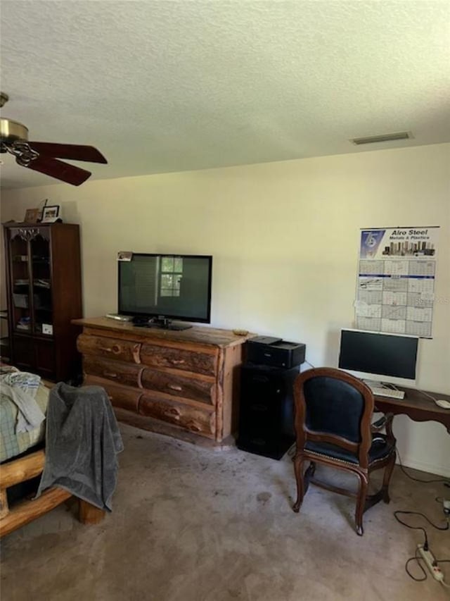 interior space featuring a textured ceiling and ceiling fan