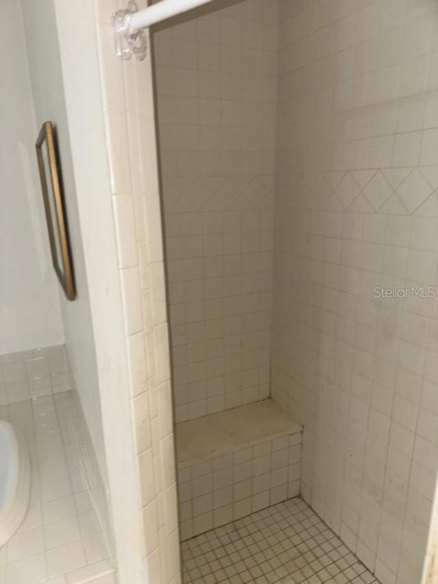 bathroom featuring a shower with shower door