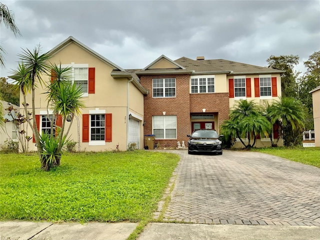 view of front of property with a front yard and a garage