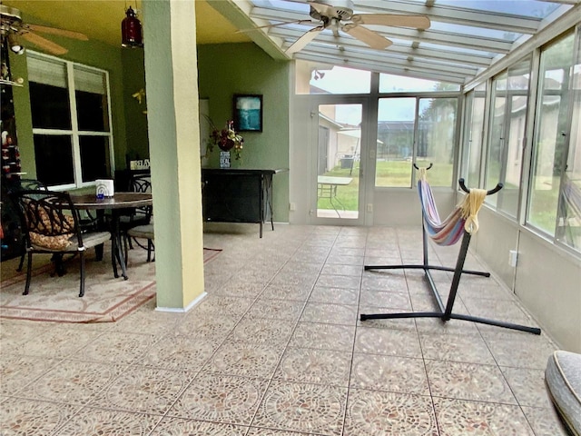 sunroom / solarium featuring vaulted ceiling, ceiling fan, and plenty of natural light