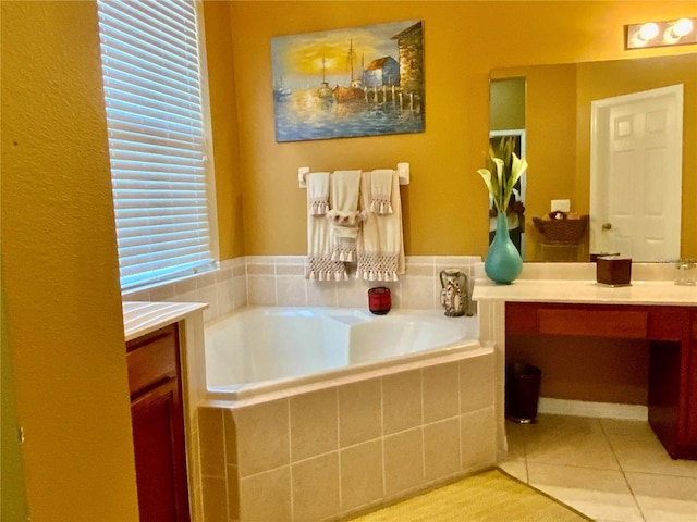 bathroom with a relaxing tiled tub, tile patterned floors, and vanity