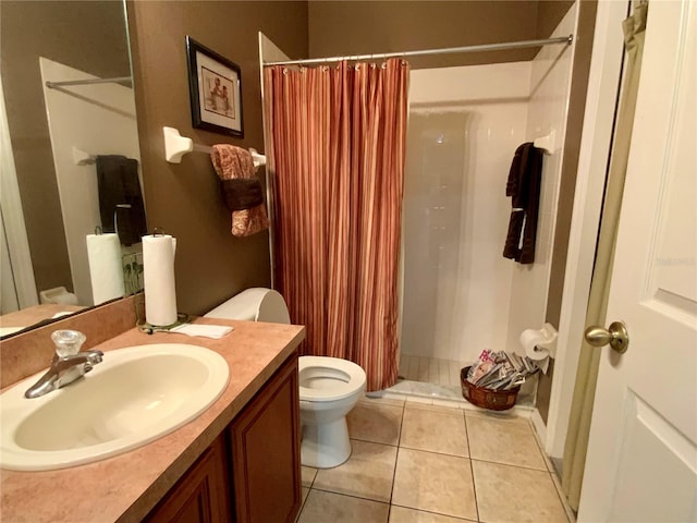 bathroom featuring walk in shower, vanity, toilet, and tile patterned floors