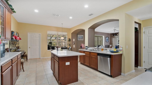 kitchen with pendant lighting, dishwasher, kitchen peninsula, a kitchen island, and ceiling fan