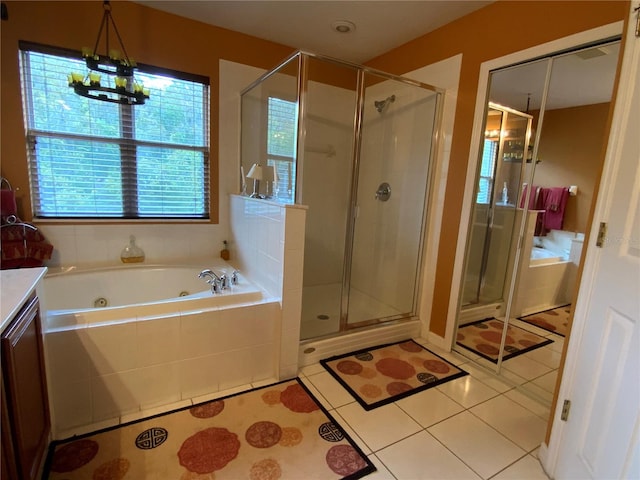 bathroom featuring vanity, a chandelier, plus walk in shower, and tile patterned floors