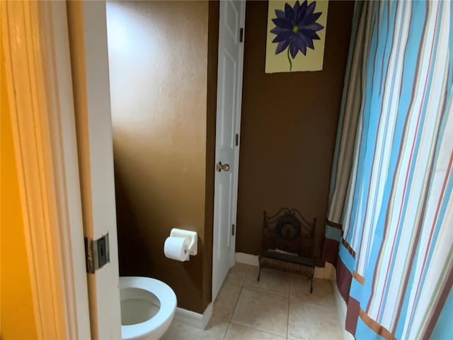 bathroom featuring tile patterned flooring and toilet