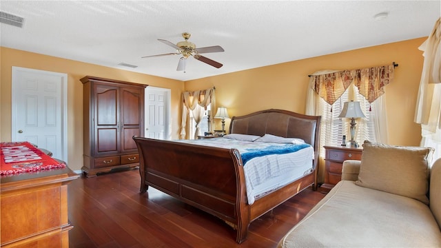 bedroom featuring a textured ceiling, dark hardwood / wood-style flooring, and ceiling fan