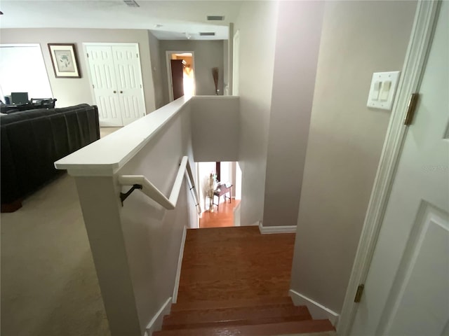 stairway featuring wood-type flooring