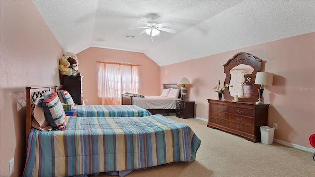 carpeted bedroom featuring lofted ceiling, ceiling fan, and a textured ceiling