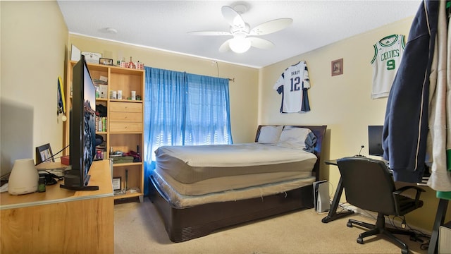 bedroom with ceiling fan, a textured ceiling, and light carpet