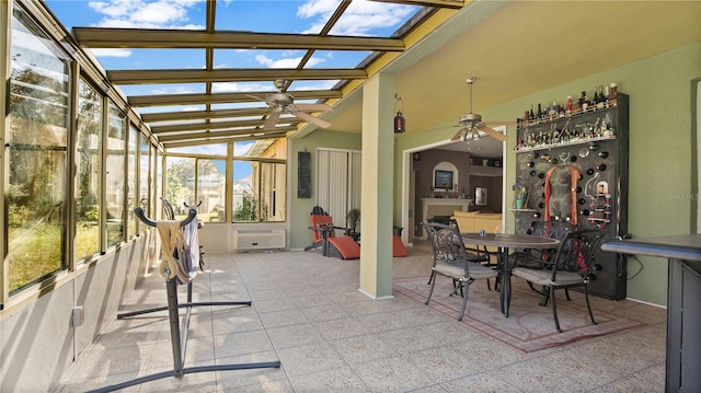 sunroom / solarium with vaulted ceiling, ceiling fan, and plenty of natural light