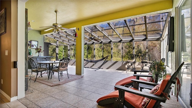 sunroom with a wealth of natural light and ceiling fan