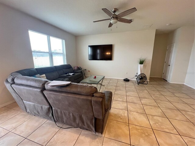 tiled living room featuring ceiling fan