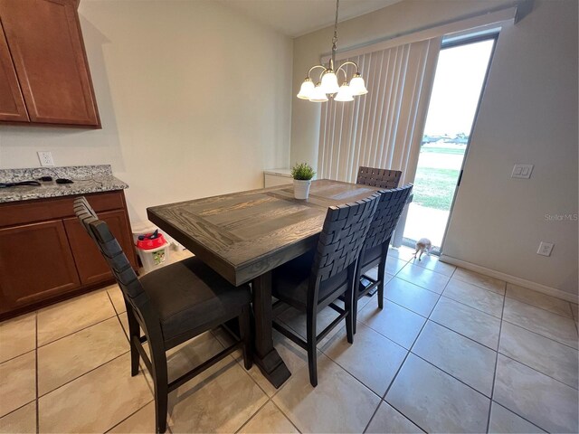 tiled dining space featuring an inviting chandelier and a wealth of natural light