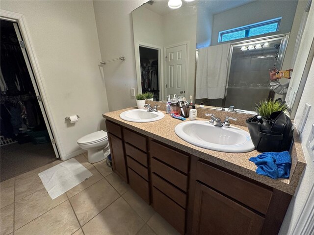 bathroom with tile patterned flooring, vanity, and toilet