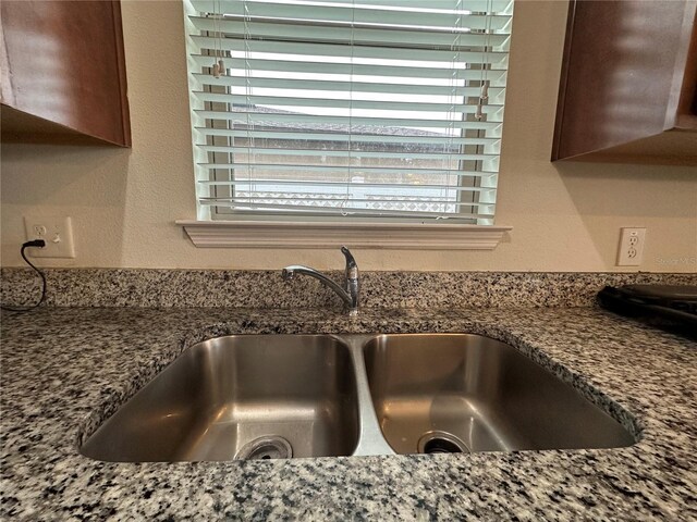 interior details featuring stone counters and sink