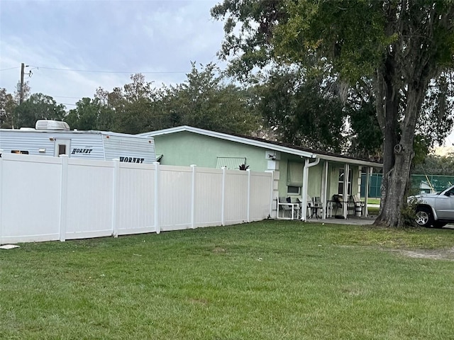 rear view of property featuring a lawn