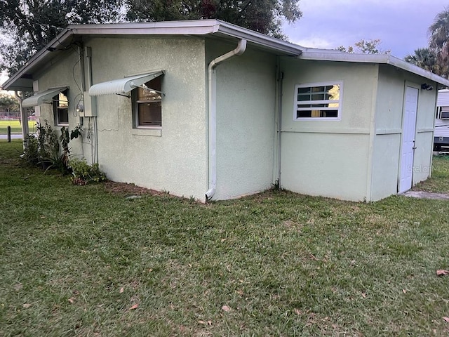 view of side of property featuring a yard