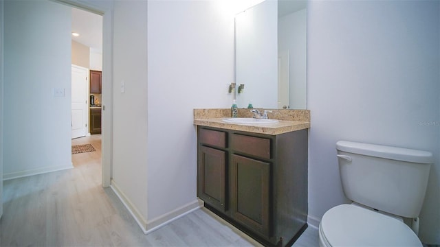 bathroom featuring hardwood / wood-style floors, vanity, and toilet