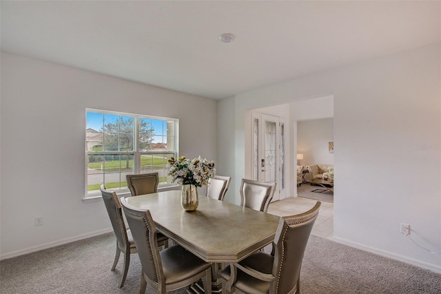 dining room featuring light colored carpet