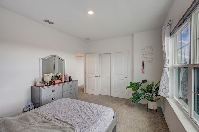 carpeted bedroom featuring a closet