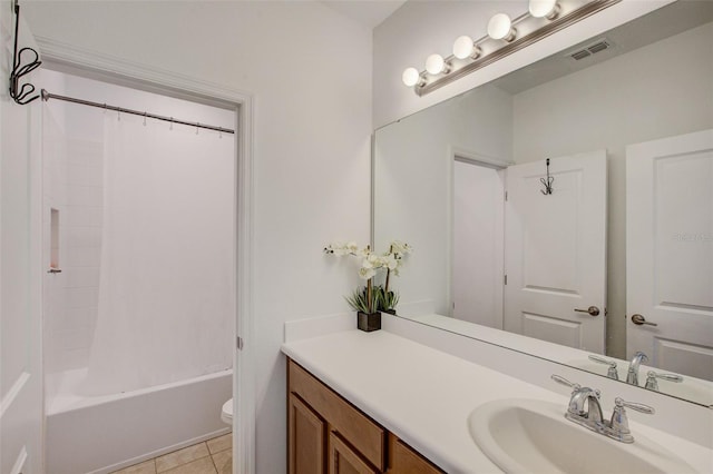 full bathroom featuring shower / bath combo with shower curtain, tile patterned floors, toilet, and vanity