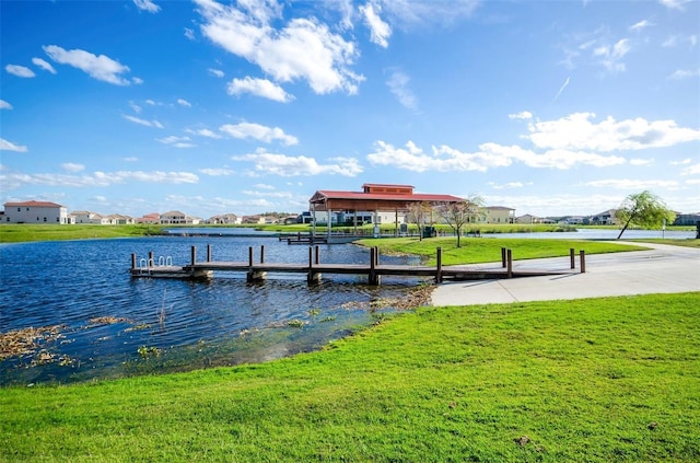 dock area featuring a yard and a water view