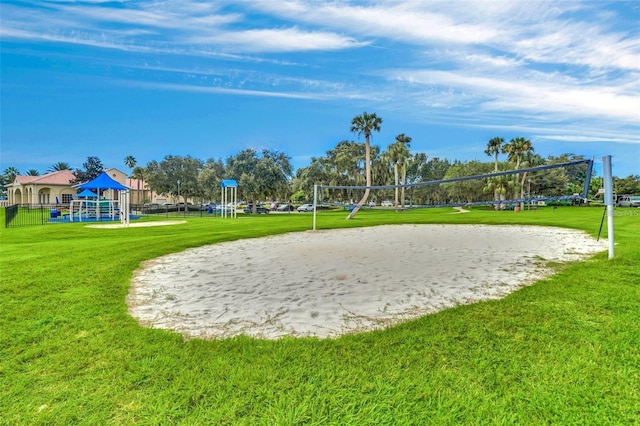 view of home's community with a playground, a lawn, and volleyball court