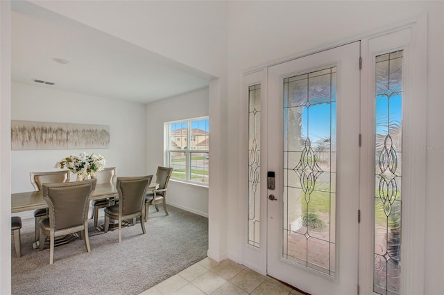 entryway featuring light carpet