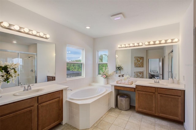 bathroom featuring tile patterned flooring, double vanity, and plus walk in shower