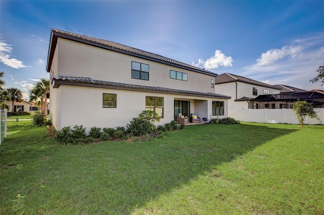 rear view of house with a yard