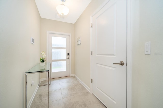 entryway with light tile patterned flooring