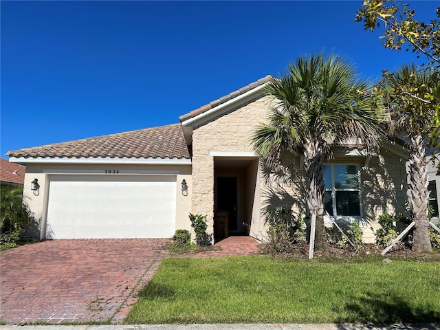 view of front of home with a front lawn and a garage