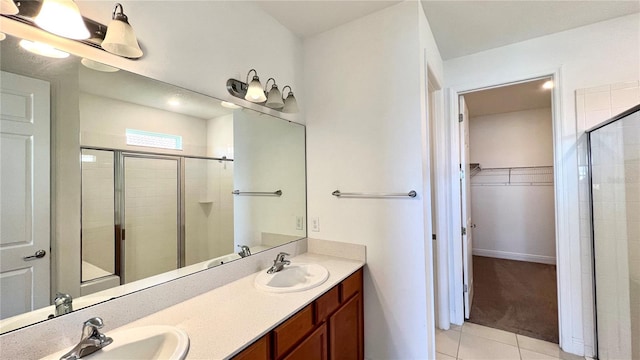 bathroom featuring walk in shower, vanity, and tile patterned flooring