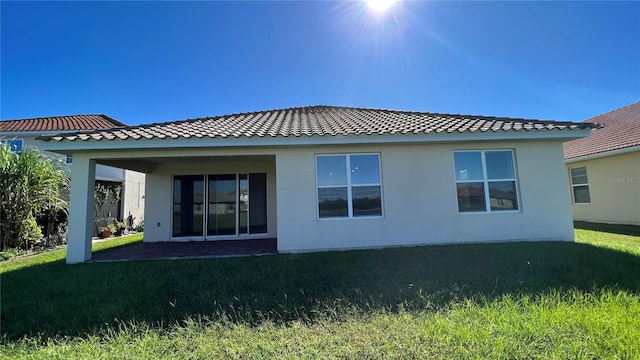 back of house with a lawn