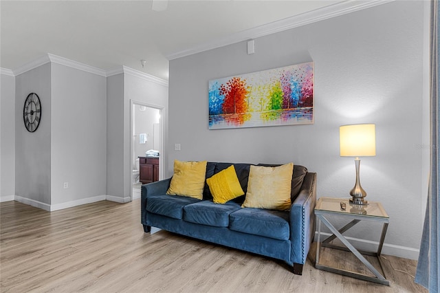 living room with light wood-type flooring and ornamental molding